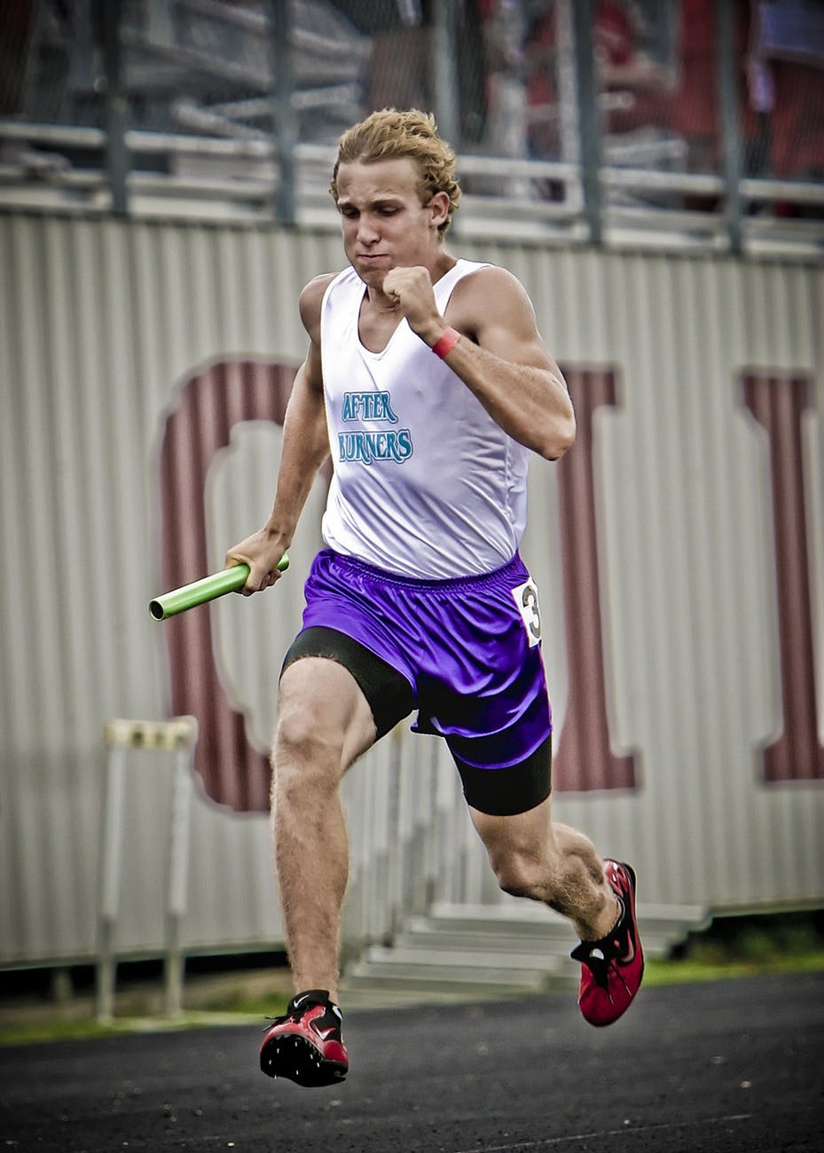 man wearing white jersey shirt running