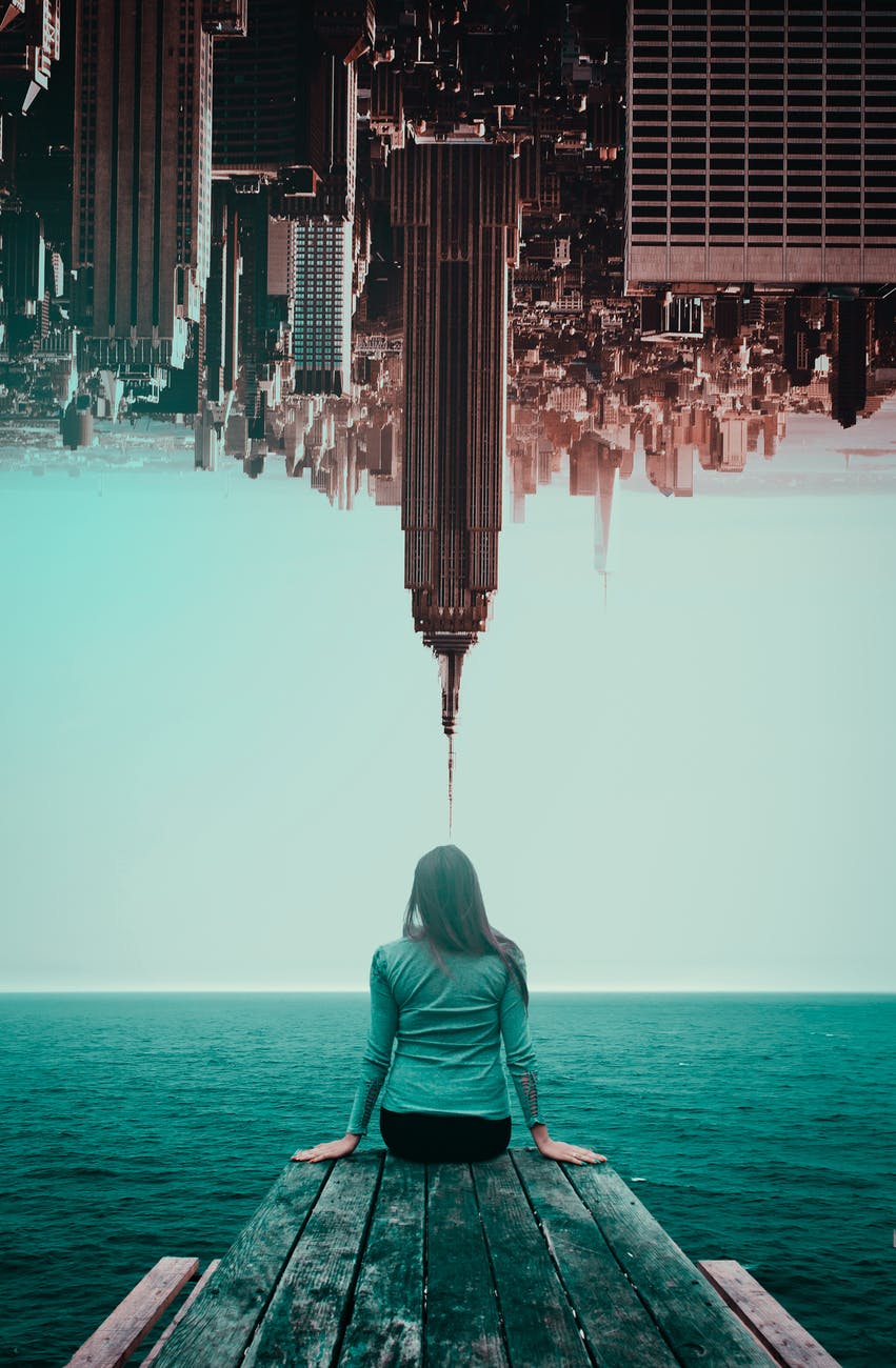 photo of woman and inverted buildings